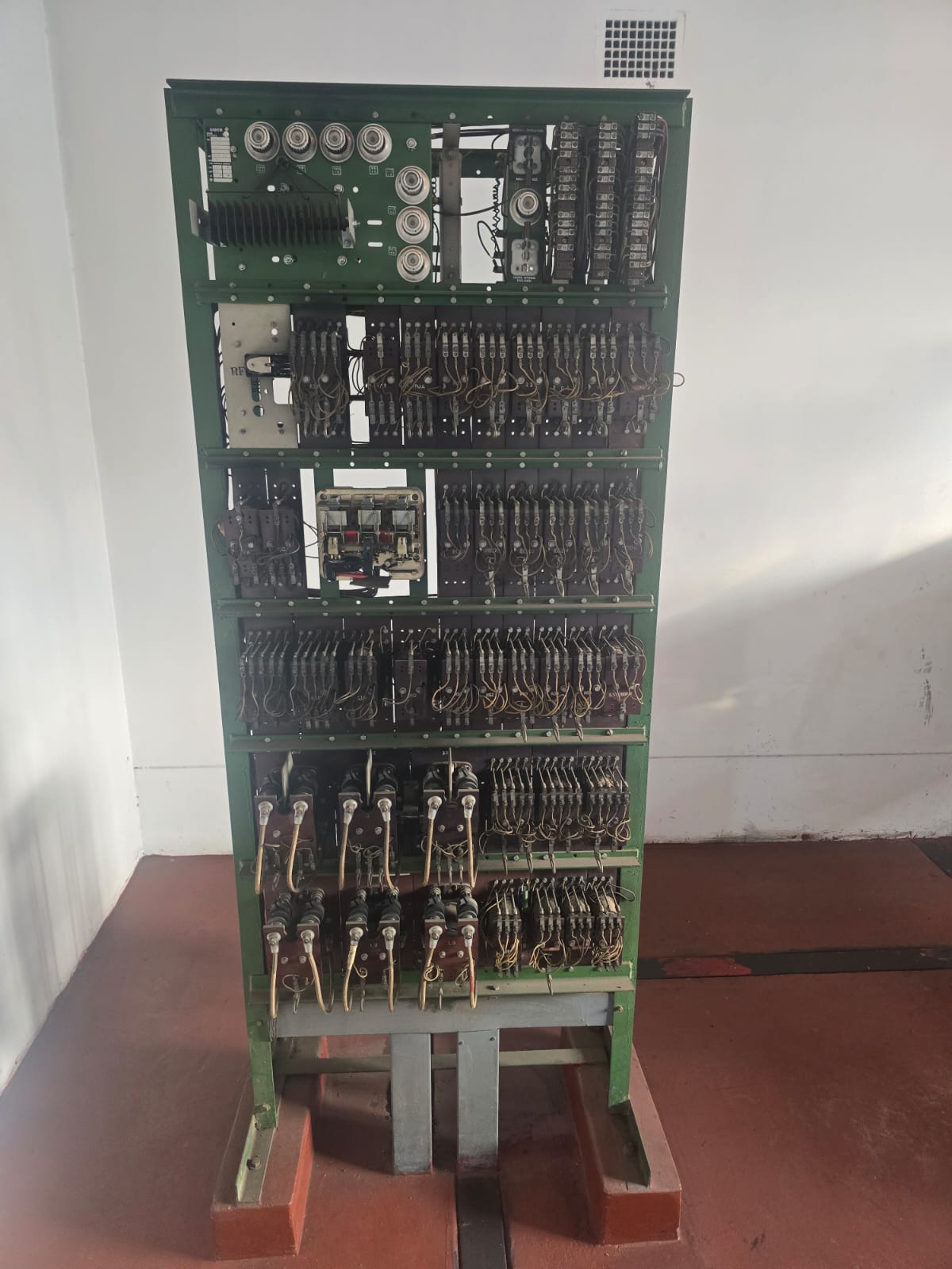 Legacy open-frame relay controller with five tiers of electromechanical relays, contactors, ceramic fuse carriers and hand-laced wiring.